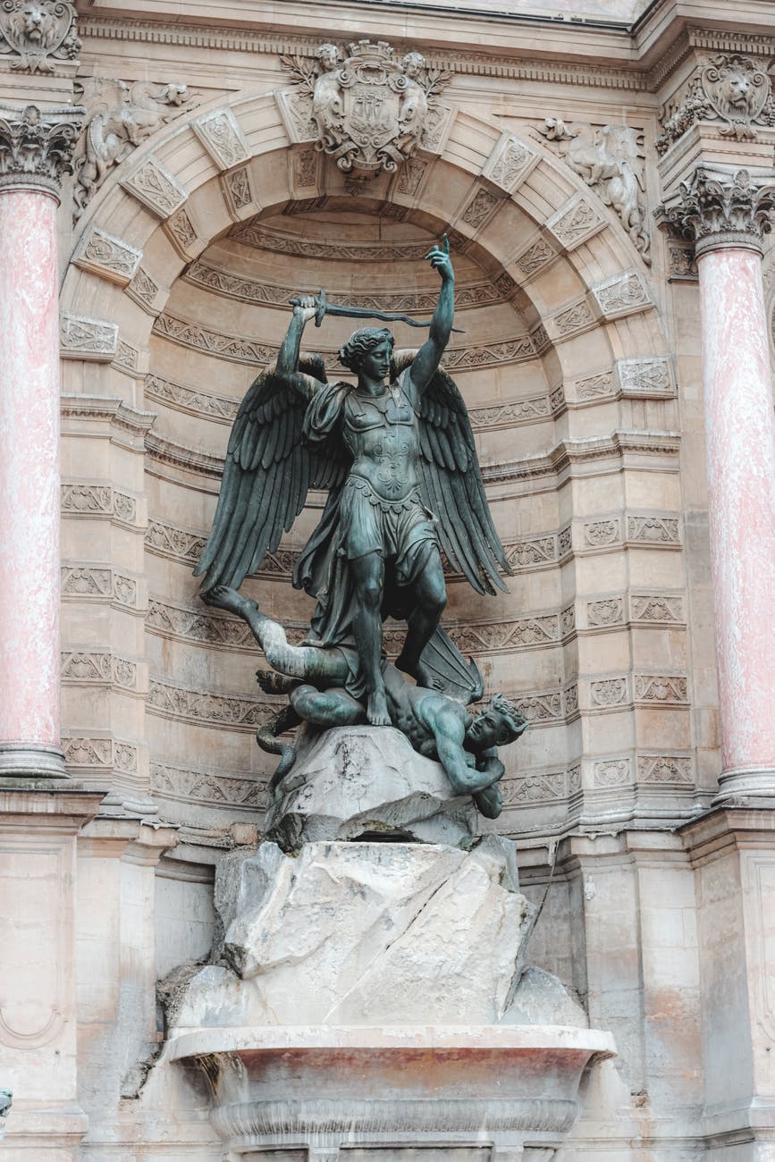 ancient statue in alcove of building